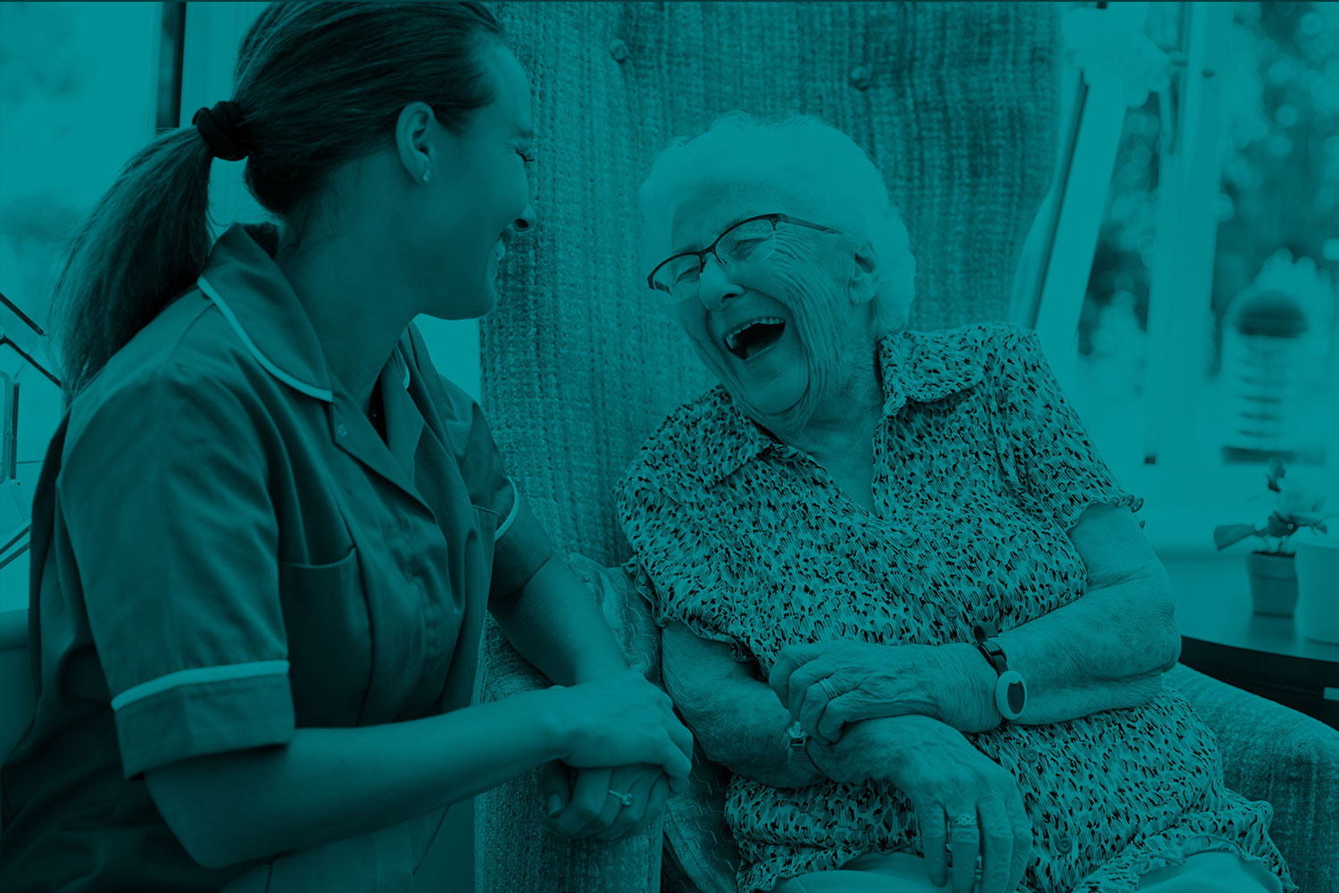 Nurse and elderly patient, laughing together